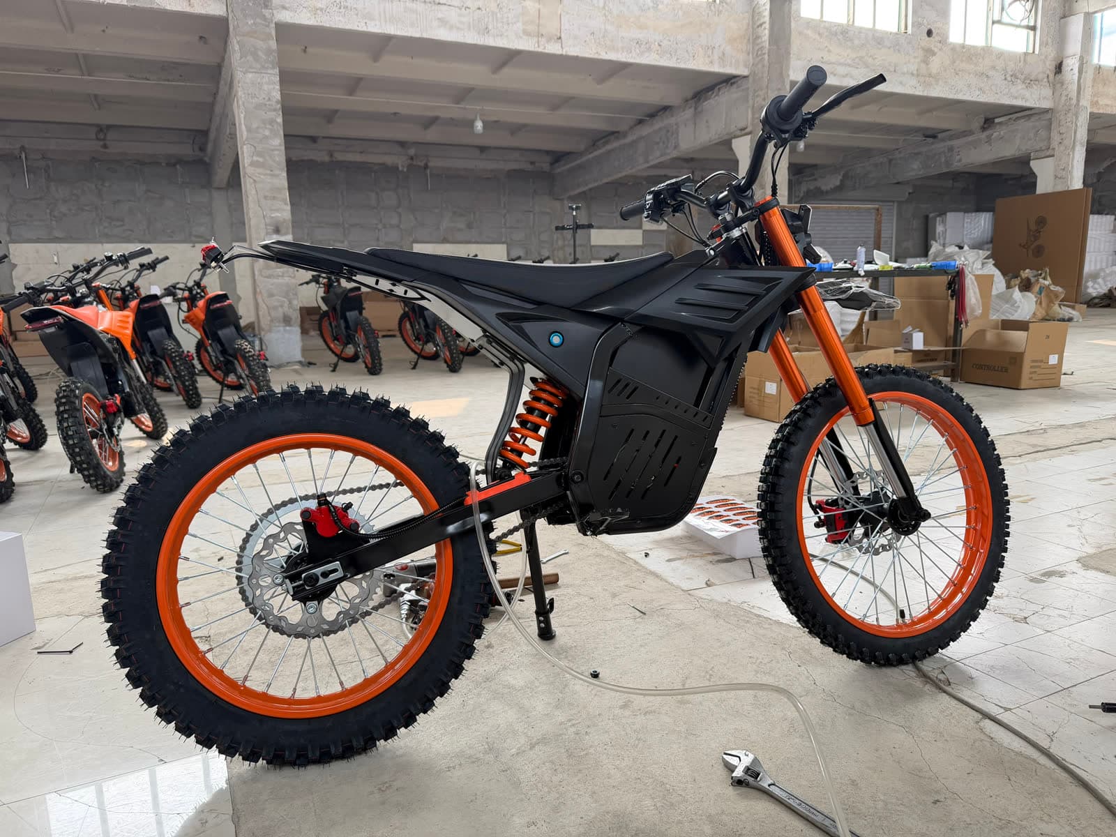 JoltMoto Trail XL — matte black, orange forks and rims, our California floor